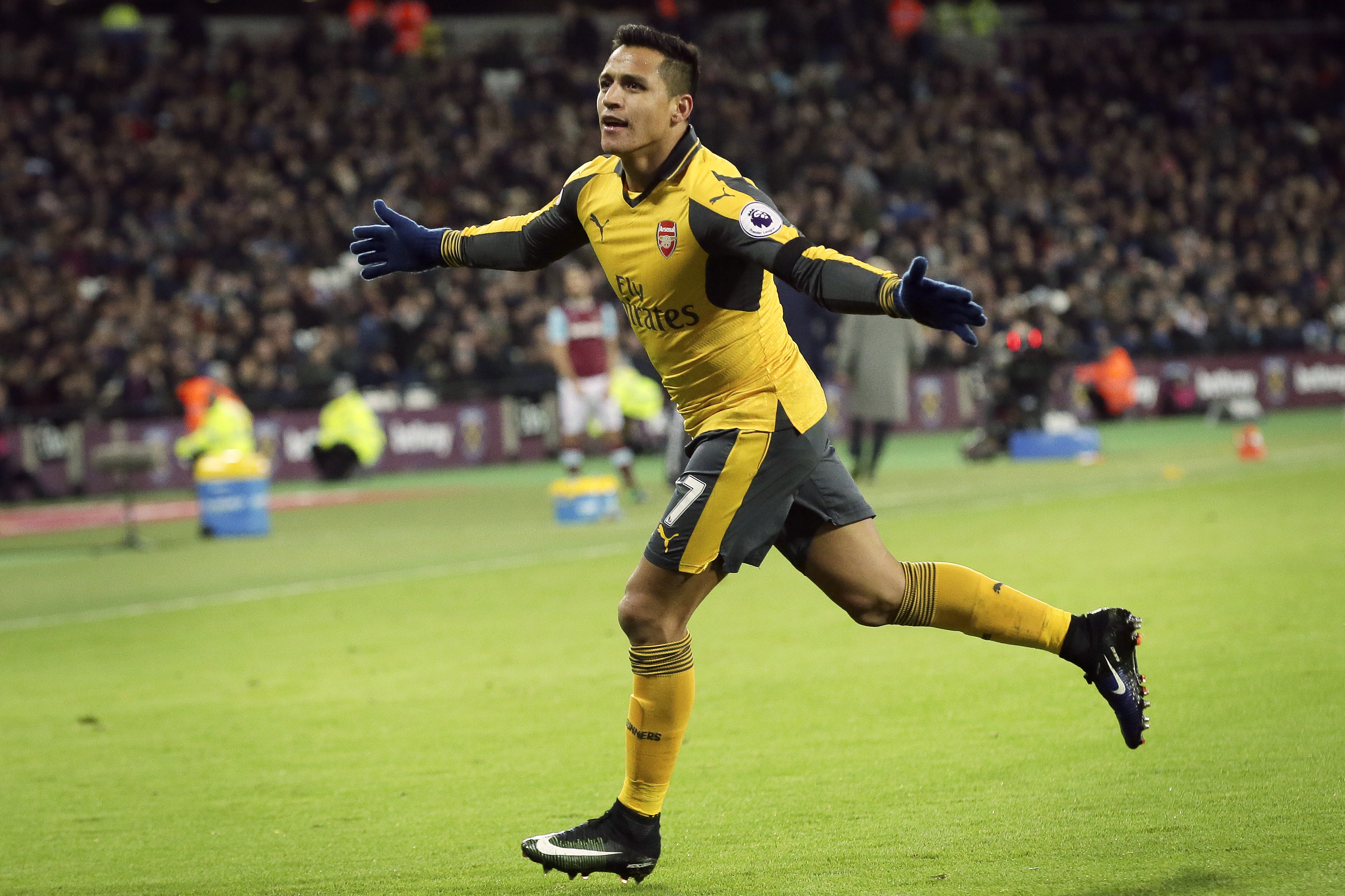 Arsenal's Alexis Sanchez celebrates after scoring a goal during the English Premier League soccer match between West Ham United and Arsenal at The London Stadium in London, Saturday Dec. 3, 2016. (AP Photo/Tim Ireland)
